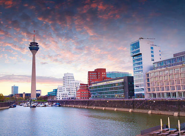 Colorful spring sunset of Rhein river at night in Dusseldorf Colorful spring sunset of Rhein river at night in Dusseldorf. Rheinturm tower and a bridge in the soft evening light, Nordrhein-Westfalen, Germany, Europe. media harbor photos stock pictures, royalty-free photos & images