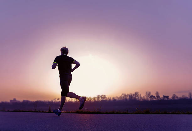 istock Running man silhouette in sunset time 473698938