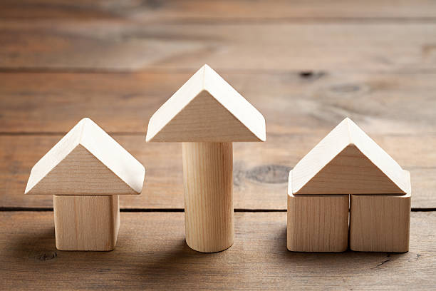 istock Wooden toy houses on old table 473699908