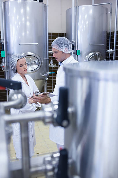 istock Biologist team talking and wearing hairnet 473702550