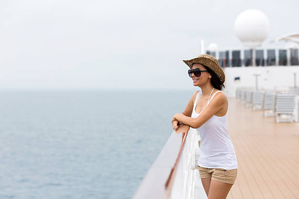 young woman looking at the sea on a cruise ship stock photo