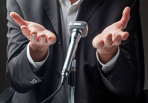 istock business or politician presentation with microphone 473703874