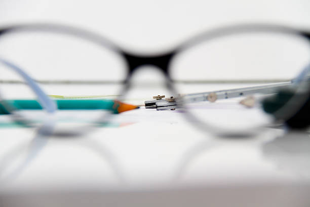 Photo of the Business Architectural project, pair of compasses, glasses, rulers and calculator - business concept