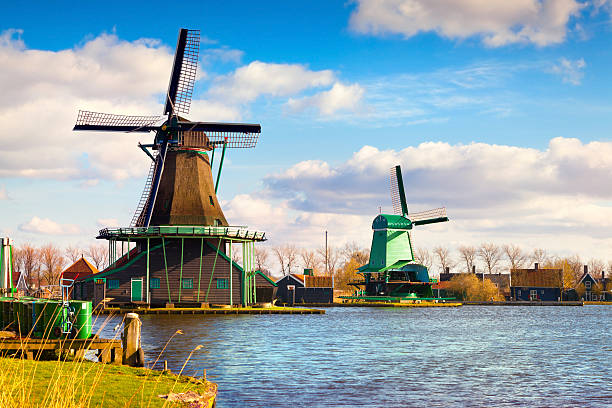 Zaandam windmills on the canal in Zaanstad village Authentic Zaandam mills on the water channel in Zaanstad willage. Zaanse Schans Windmills and famous Netherlands canals. zaanse schans stock pictures, royalty-free photos & images