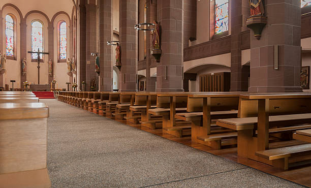 istock Inside church view rows benches aisle altar cross saint statues 473709460