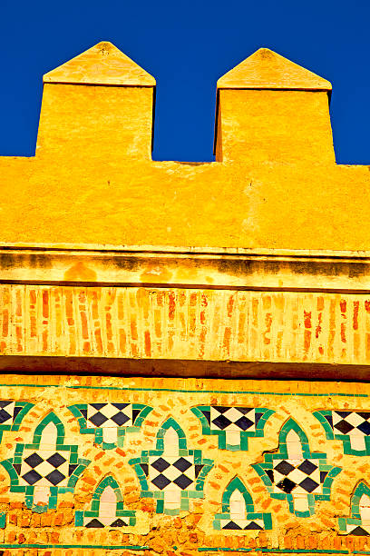 old ruin in  brown construction  africa    morocco and sky  near the tower