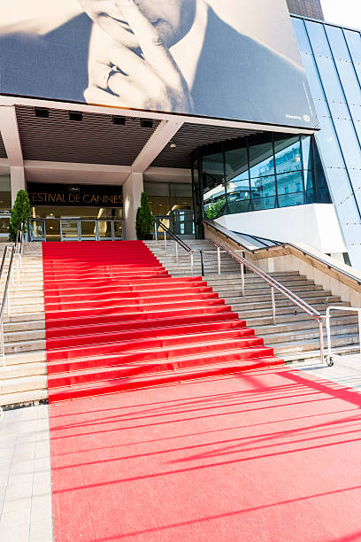 Cannes Film Festival Red Carpet Cannes, France - May 24, 2014: Great Auditorium of the entrance door at Cannes in France, the famous red carpeted stairs.  cannes film festival stock pictures, royalty-free photos & images