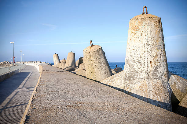 istock Sea pier and concrete block breakwaters. 473711908