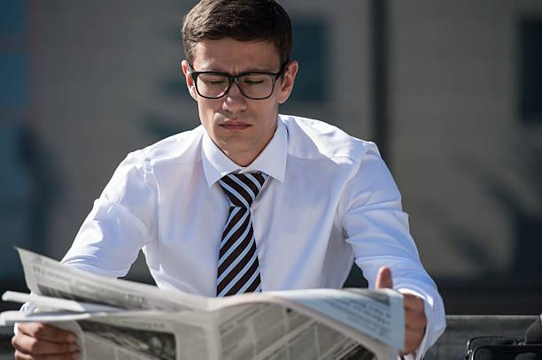 istock Businessman reading newspaper during break 473712520