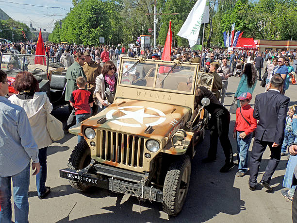 Voronezh, Russia - May 9, 2015: city dwellers look round military retrocar of World War II four-whee-drive jeep Willys MB on the city central square during the celebration of Victory V-E Day