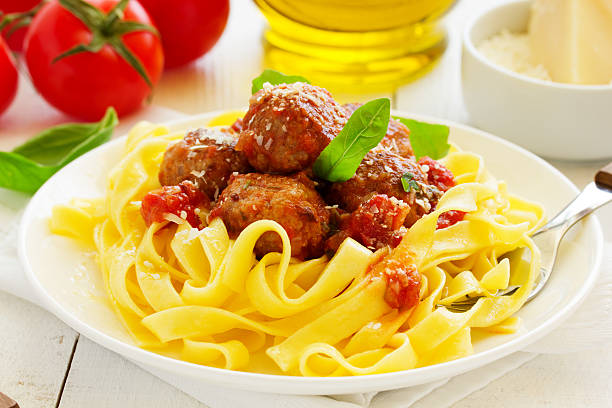 istock Egg tagliatelle with meatballs in tomato sauce. 473723890