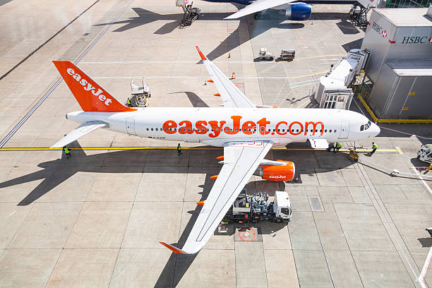 EasyJet airlines Airbus A320 at London Gatwick airport. London, United Kingdom - May 7, 2015: EasyJet airlines Airbus A320 at Gatwick LGW airport while refueling. airbus a320 stock pictures, royalty-free photos & images