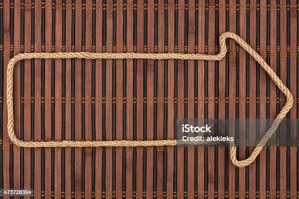 Arrow Made Of Rope Lies On A Bamboo Mat Stock Photo - Download Image Now - 2015, Arrow Symbol, Backgrounds