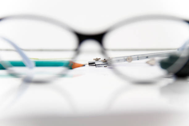 Photo of the Business Architectural project, pair of compasses, glasses, rulers and calculator - business concept