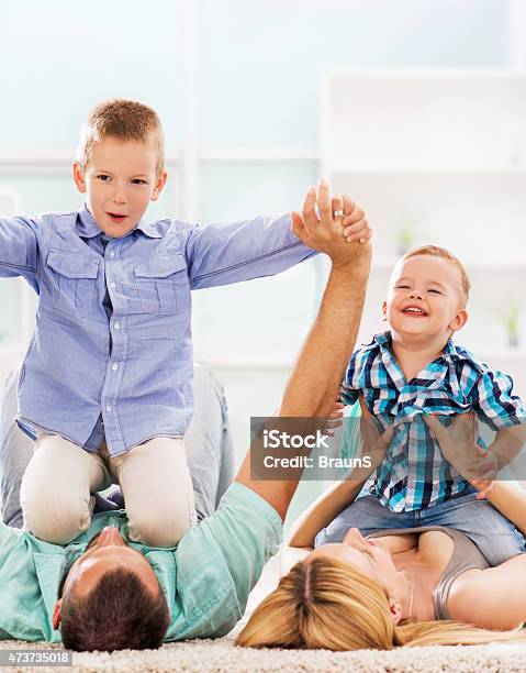 Happy Parents Playing With Their Small Children And Having Fun Stock Photo - Download Image Now