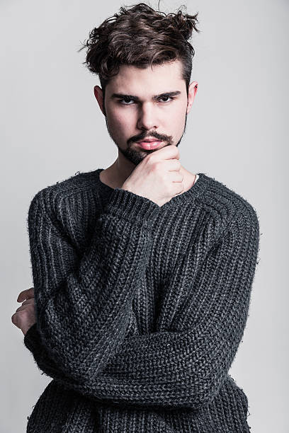 istock Portrait of a young man in gray pullover 473737296