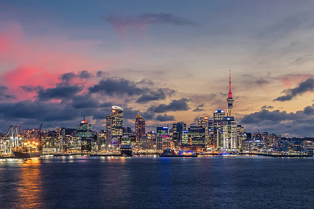 Auckland city with dramatic sunset sky Dramatic shot of Auckland City as the sun is setting and the lights turn on. auckland stock pictures, royalty-free photos & images