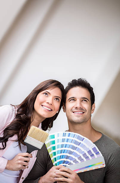 istock Thoughtful couple painting their house 473741106