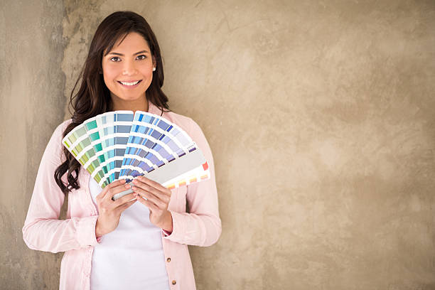istock Woman painting her house 473741108