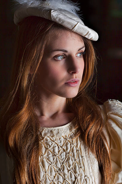 istock Medieval Lady Wearing A Cream Dress And Hat 473741304