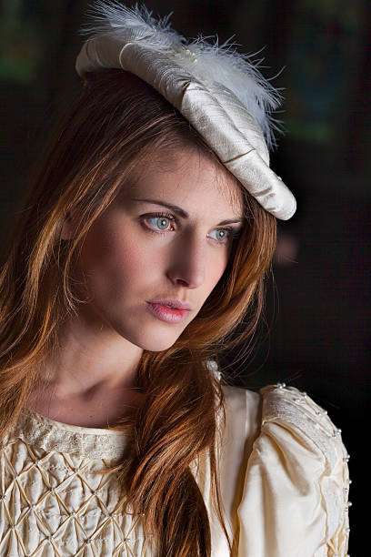 istock Medieval Lady Wearing A Cream Dress And Hat 473741306