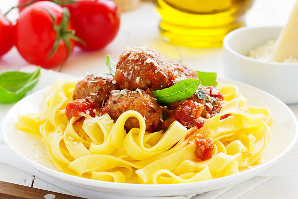 istock Egg tagliatelle with meatballs in tomato sauce. 473744876