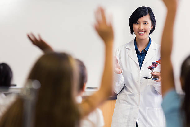istock Asian teacher smiling, asking questions in private elementary science class 473745180