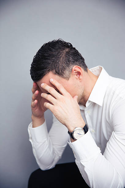 istock Depressed businessman over gray background 473745192