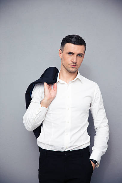 istock Pensive businessman holding jacket on shoulder 473745220