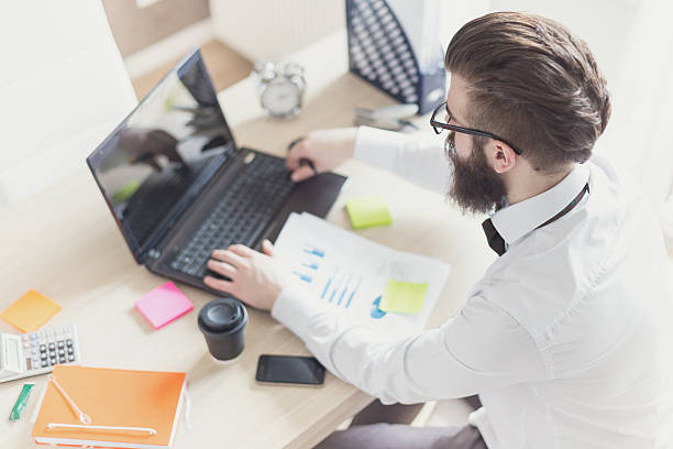 istock Business man in office from above 473745820