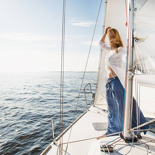 istock woman staying on sailboat 473746414
