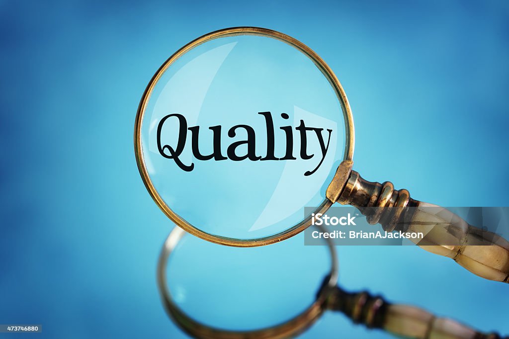 Magnifying glass focus on word quality Magnifying glass focus on word quality concept for quality control, customer satisfaction and excellence Focus - Concept Stock Photo