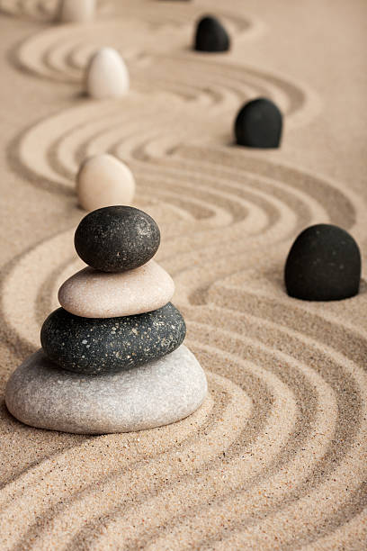 istock Pyramid  made of  stones standing on the sand 473747394