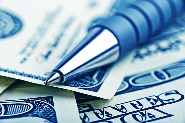 close-up pen on the money stock photo