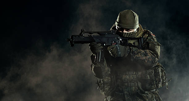 istock Soldier in an attack/defensive position. Going up in smoke. 473749718
