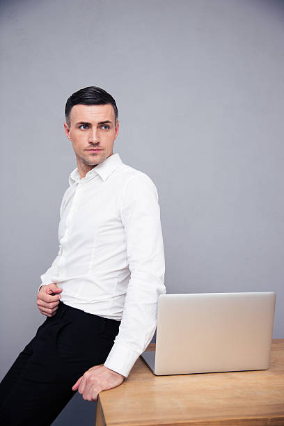 istock Businessman leaning on the table with laptop 473750266