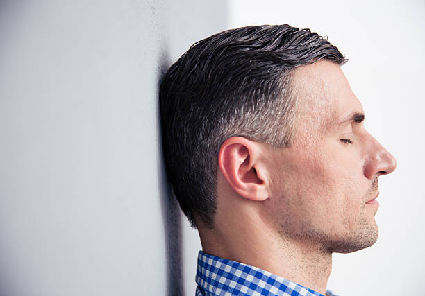 istock Relaxed man leaning on the wall 473752740