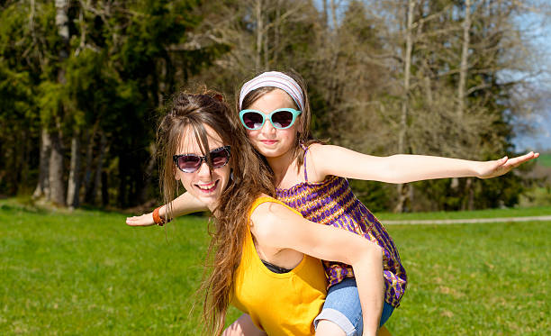 istock Mom and daughter play in nature 473758720