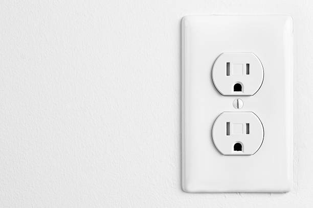 istock White Electrical Outlet and Wall Plate on painted white wall 473762148