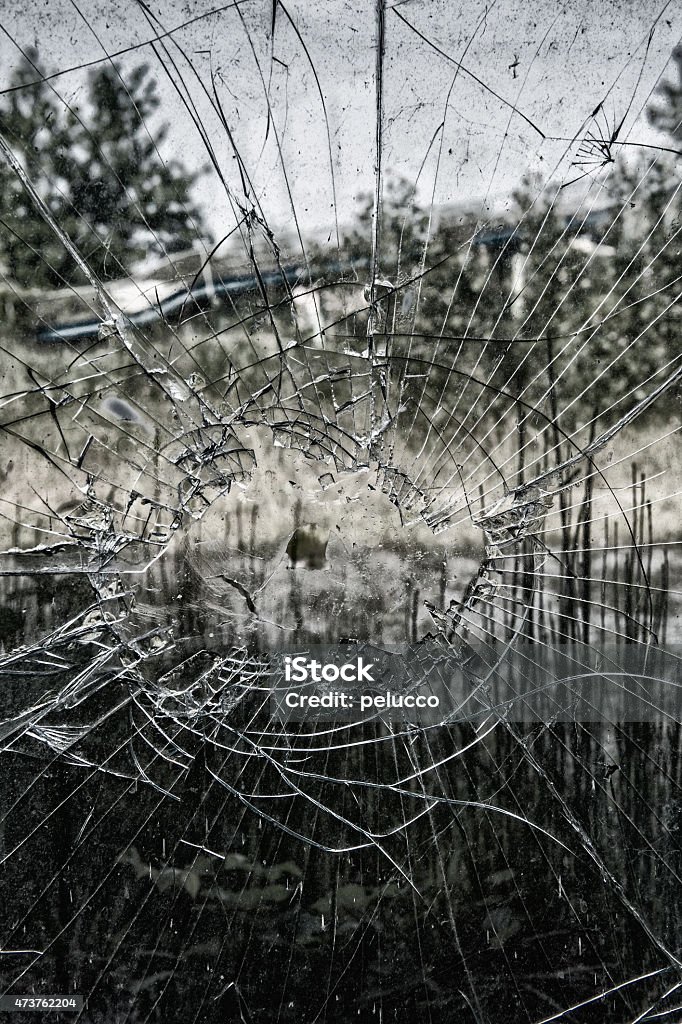 Shattered glass Close up of broken window pane against blue sky. 2015 Stock Photo