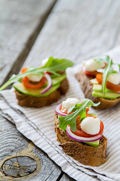 istock Summer sandwiches - avocado, tomato, red onion, mozzarella, ruccola 473762588