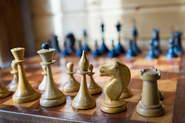 istock Old Craved wooden Chess pieces on a Board 473768668