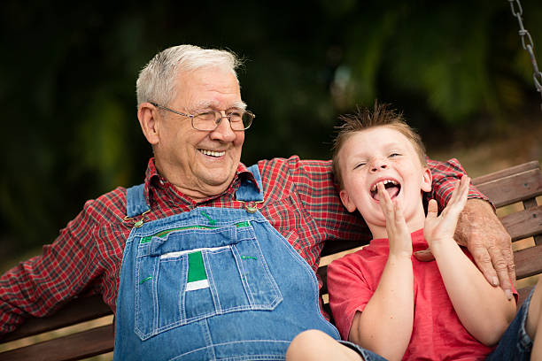 istock Senior Man Laughing With His Great Grandson on Swing 473778122