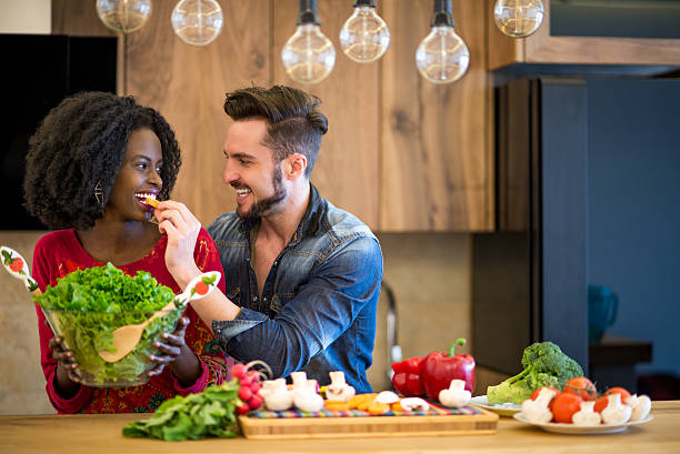 istock Man feeding woman with carrot 473778492