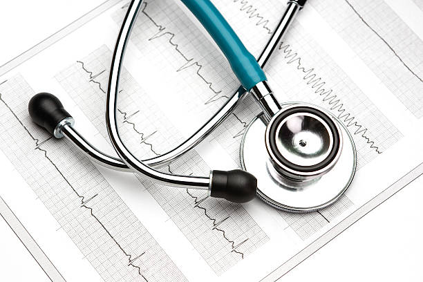 istock Cardiology - Pulse trace report from a EKG and a stethoscope 473778514