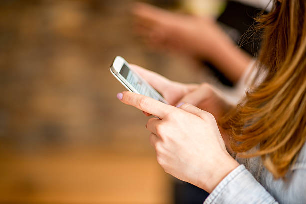 istock Female hands holding smart phone 473781028