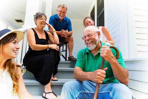 Grandpa Tells Funny Story to Friends and Family stock photo