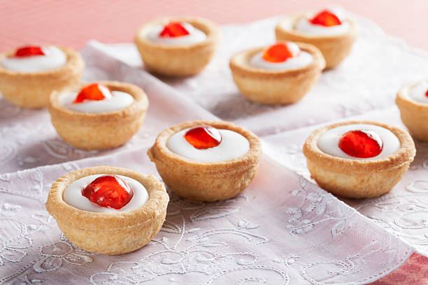 Bakewell Pastries Sweet bakewell pastry treats on white napkin. bakewell stock pictures, royalty-free photos & images
