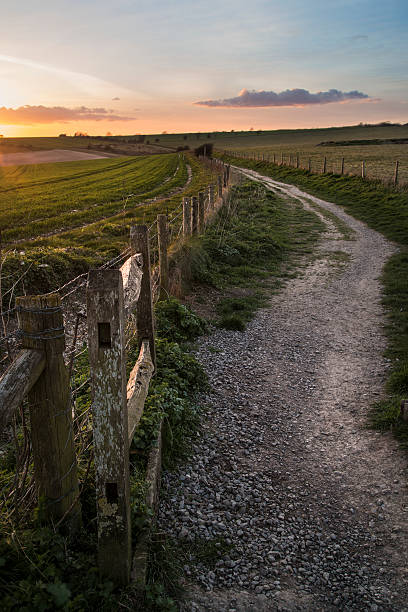 istock Beautiful Spring landscape of gate leading footpath into fields 473785714
