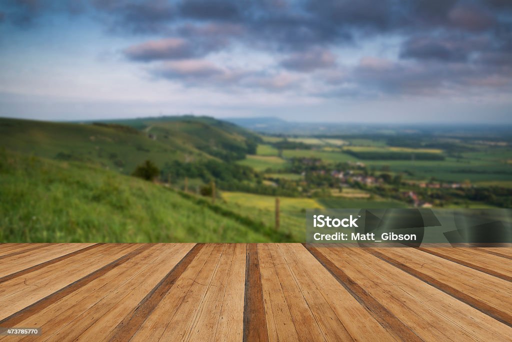 Vibrant sunrise over countryside landscape with wooden planks fl Beautiful vibrant sunrise over rolling countryside landscape with wooden planks floor 2015 Stock Photo